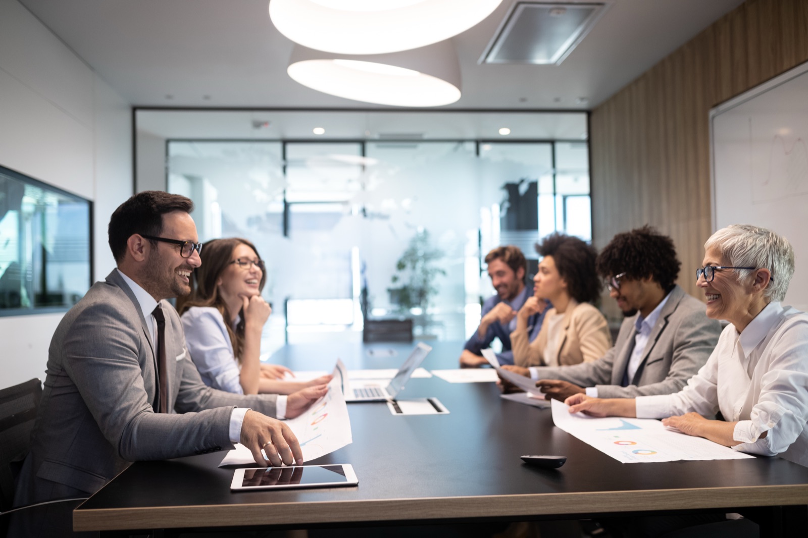 Board members talking around a conference table