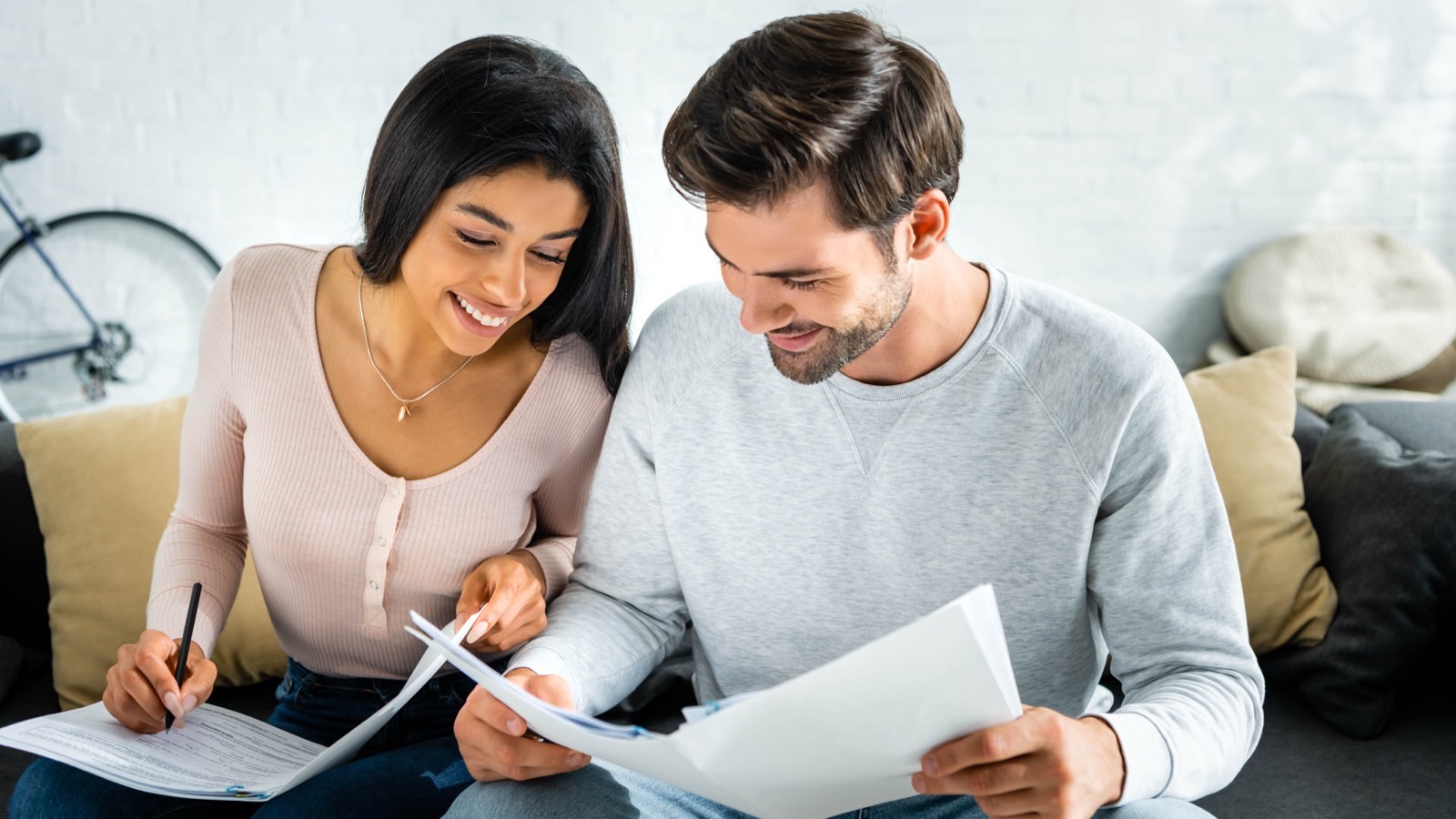A couple reviewing paperwork together at home
